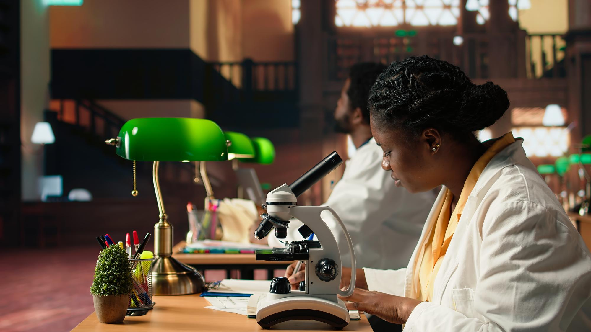 Illustrative photograph of a researcher working at a microscope